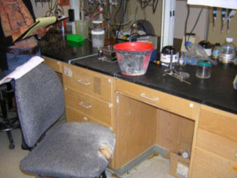 lab bench with burned ice bucket and burned chair