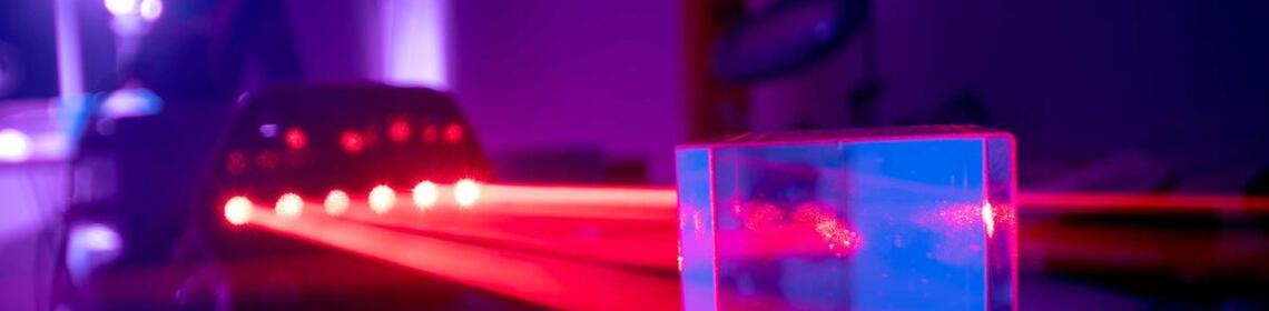 Two researchers performing experiment with lasers