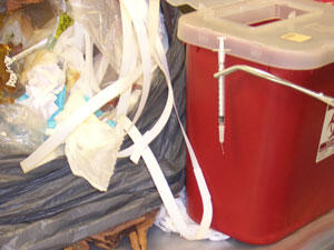 Combined-waste trash bag containing sharps